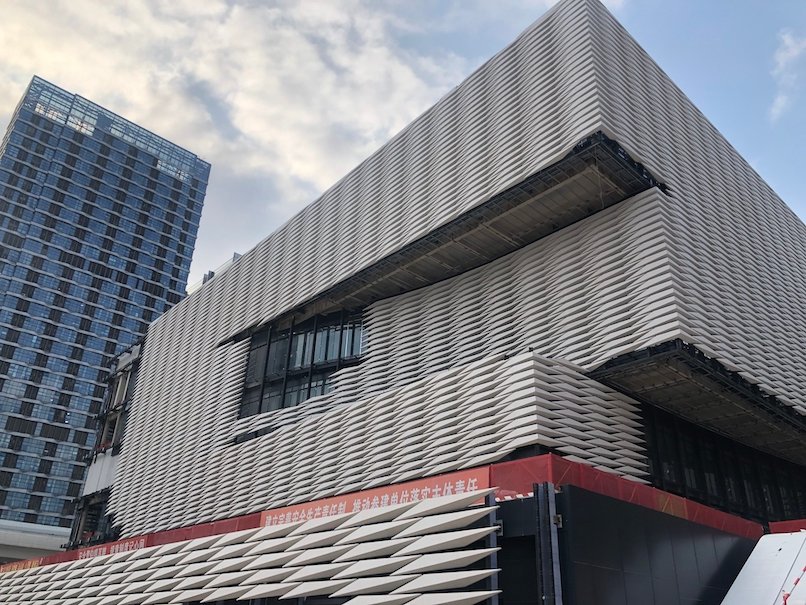 completed commercial building facade with white limestone cladding