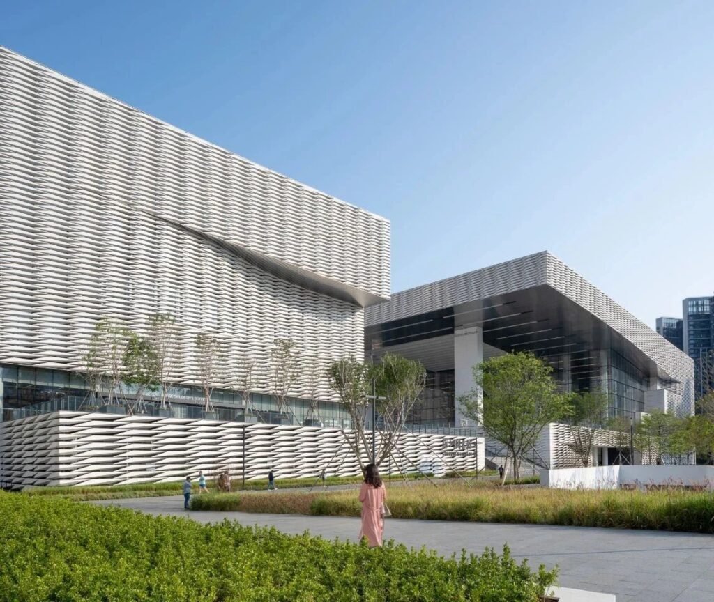 modern commercial building facade clad with beige limestone panels
